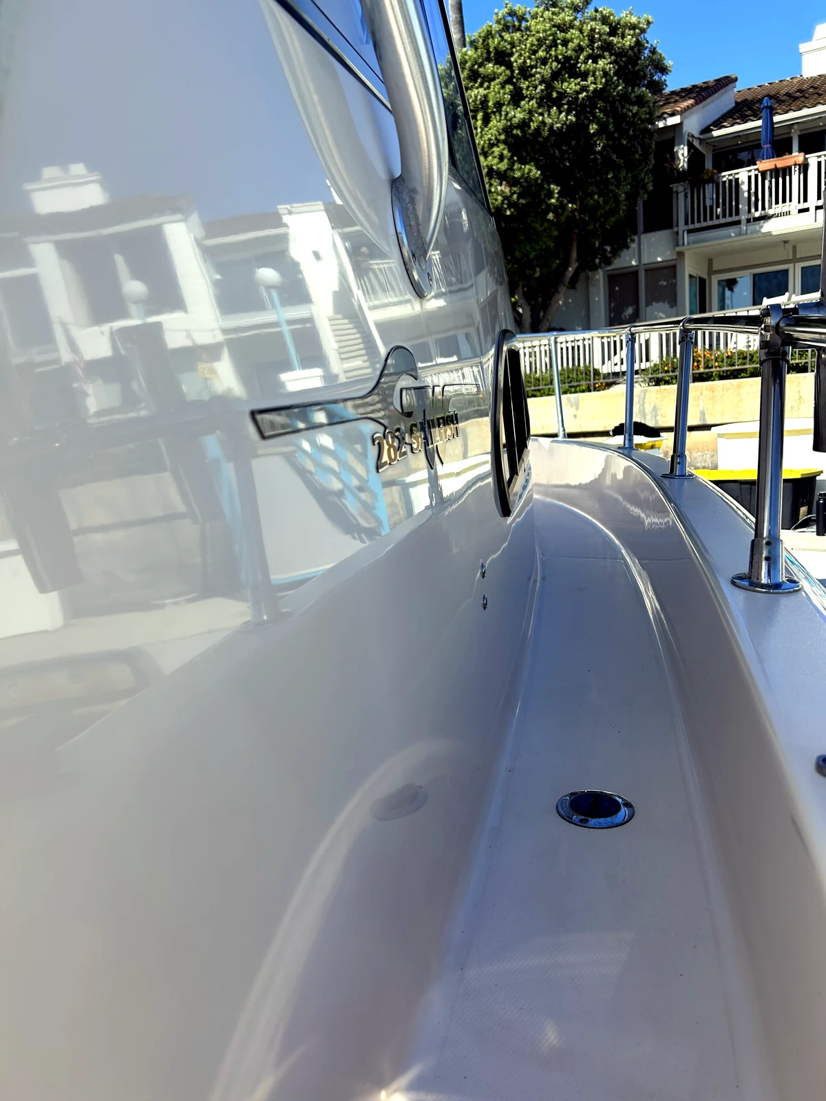 Polished yacht hull reflecting the marina after a HarborSide detail