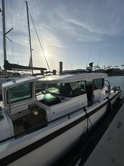 White cabin boat docked at the marina at sunset after a HarborSide detail