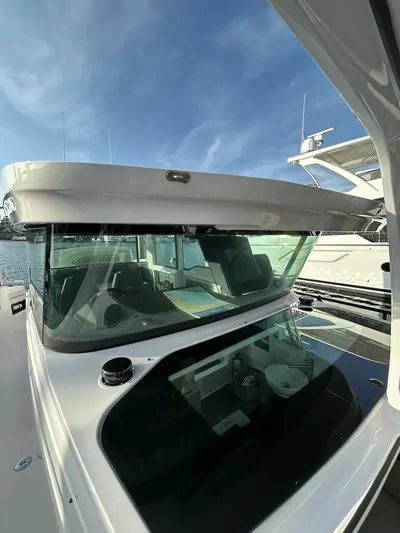 Detailed powerboat helm and hardtop with polished glass and gelcoat