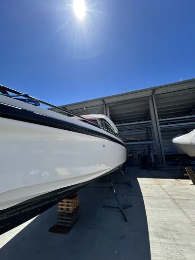 Glossy white boat hull on stands at the boatyard after a HarborSide detail and polish
