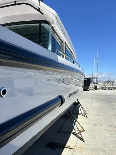 Glossy detailed hull with polished topsides and a crisp blue accent stripe