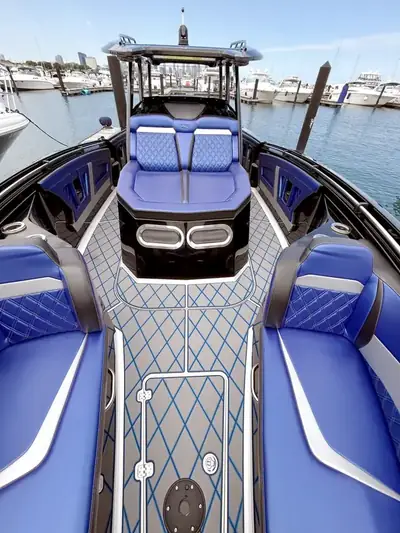 Center-console boat with vivid blue decking and seating after a complete detail